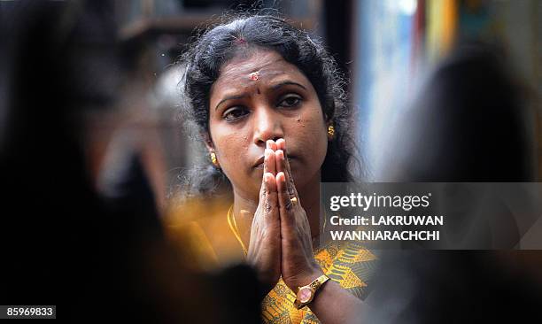 Sri Lankan woman offers prayers at a Hindu Temple in celebration of the traditional Sinhala and Tamil New Year in Colombo on April 14, 2009. The...