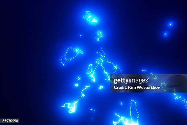 bright irregular lines glowing blue in darkness  - westerskov stock pictures, royalty-free photos & images