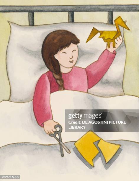 Sadako in her bed making a paper crane, from the real story of Sadako Sasaki and the Thousand Paper Cranes, survivor of the Hiroshima atomic bomb,...