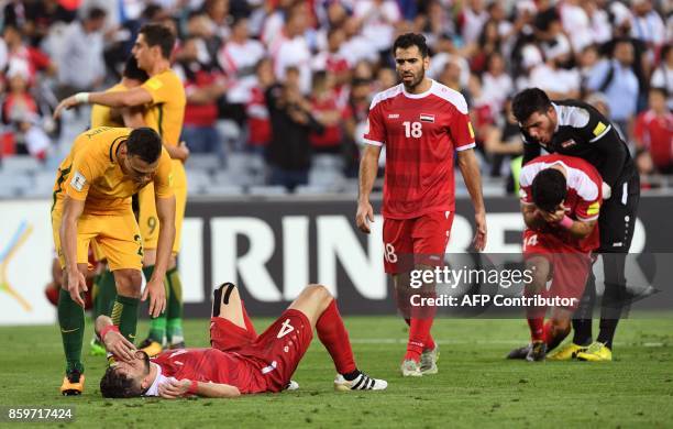 Trent Sainsbury of Australia consoles Syrian Jehad Al Baour after Australia defeated Syria in their 2018 World Cup football qualifying match played...