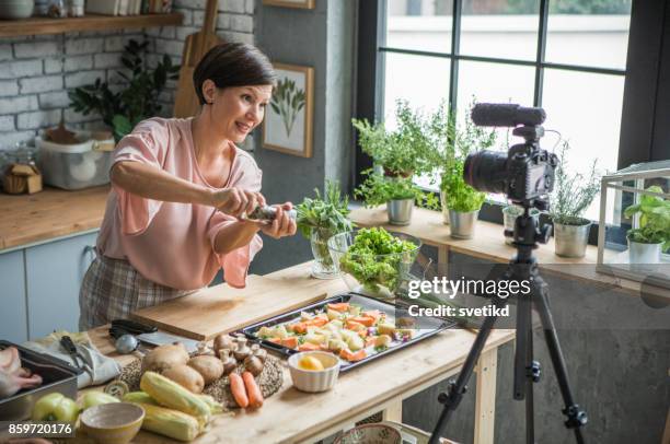 she is enjoying at cooking and vlogging - cooking show stock pictures, royalty-free photos & images