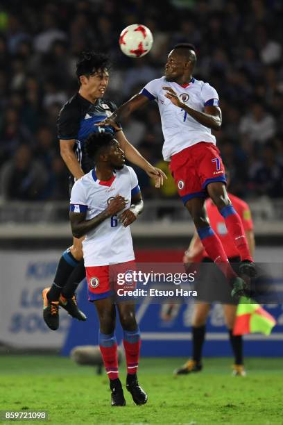 Wataru Endo of Japan and Wilde-Donald Guerrier of Haiti compete for the ball during the international friendly match between Japan and Haiti at...