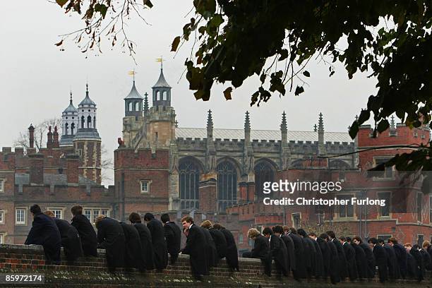 Eton boys, perched on the wall, watch the tradtional wall game on November 17, 2007 in Eton, England. The game which is unique to Eton, is played...