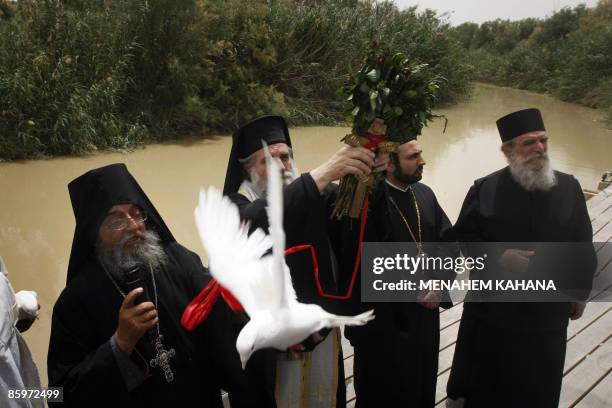 Christian Greek Orthodox priests free a dove during a mass in the Qasr al-Yahud baptism site on the Jordan River on April 14, 2009. Thousands of...