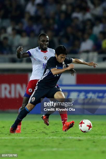 Shinji Kagawa of Japan is tackled by Andrew Anderson Jean-Baptiste of Haiti during the international friendly match between Japan and Haiti at Nissan...