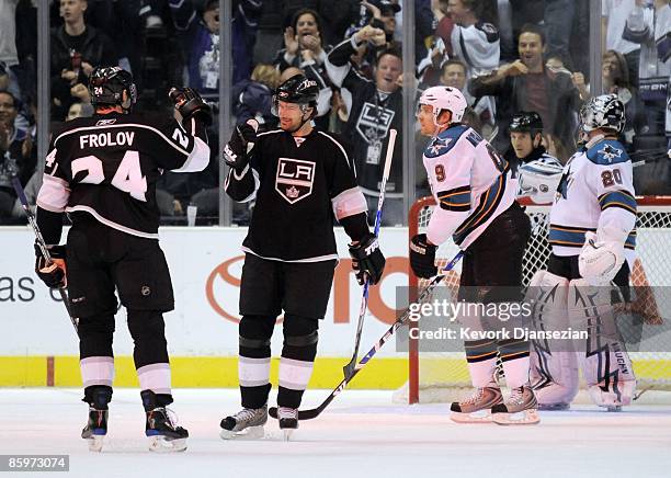 Alexander Frolov of the Los Angeles Kings is congratulated by teammate Justin Williams as goalkeeper Evgeni Nabakov and Joe Pavelski of the San Jose...