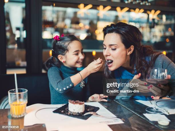 mother and daughter in restaurant - eating yummy stock pictures, royalty-free photos & images