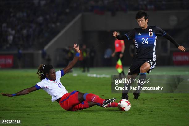 Shintaro Kurumaya of Japan is tackled by Samuel Maedochee Pompe of Haiti during the international friendly match between Japan and Haiti at Nissan...