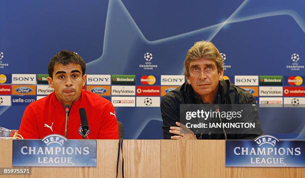 Manager of Villareal Manuel Pellegrini answers questions with Villareal's Argentinian footballer Ariel Ibagaza during a press conference at The...