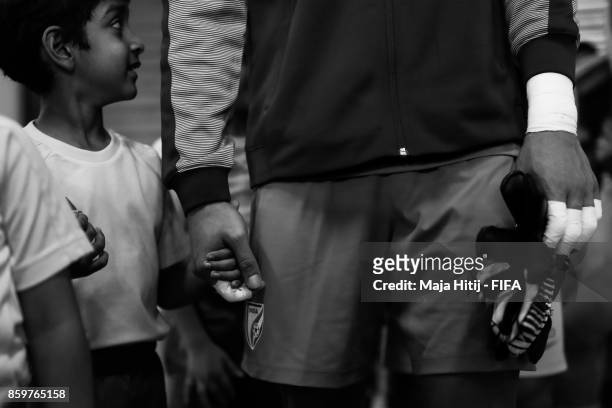 Boris Thangjam of India stands with a boy prior the FIFA U-17 World Cup India 2017 group A match between India and Colombia at Jawaharlal Nehru...
