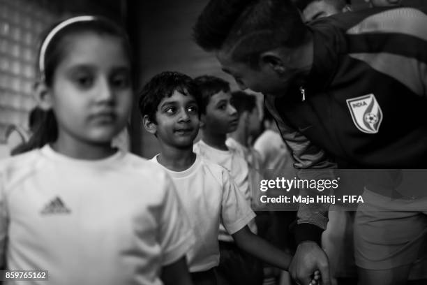 Boris Thangjam of India talks to a boy prior the FIFA U-17 World Cup India 2017 group A match between India and Colombia at Jawaharlal Nehru Stadium...