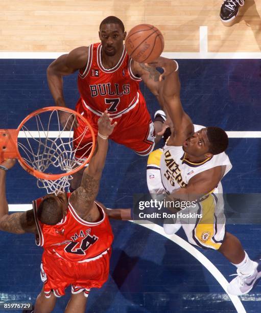 Roy Hibbert of the Indiana Pacers puts up a shot under pressure over Tyrus Thomas and Ben Gordon of the Chicago Bulls during the game on March 31,...