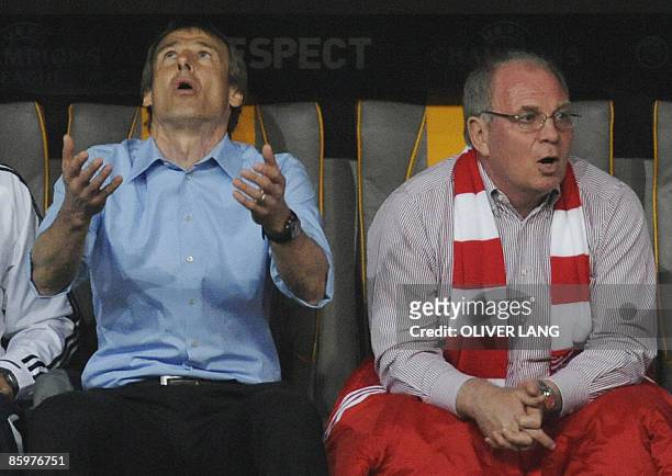 Bayern Munich's coach Juergen Klinsmann and team manager Uli Hoeness react during the second leg Champions League quarter-final match Bayern Munich...