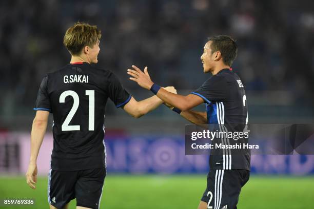 Gotoku Sakai of Japan celebrates his side's third goal with his team mate Yosuke Ideguchi during the international friendly match between Japan and...