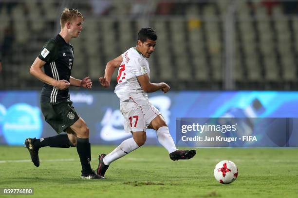 Mohammad Ghaderi of Iran sees his shot at goal go wide under pressure from Jan Boller of Germany during the FIFA U-17 World Cup India 2017 group C...