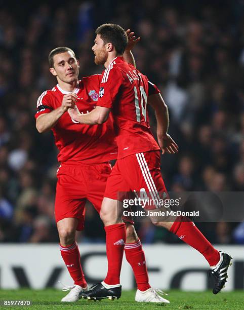 Xabi Alonso of Liverpool celebrates his goal with team mate Fabio Aurelio during the UEFA Champions League Quarter Final Second Leg match between...