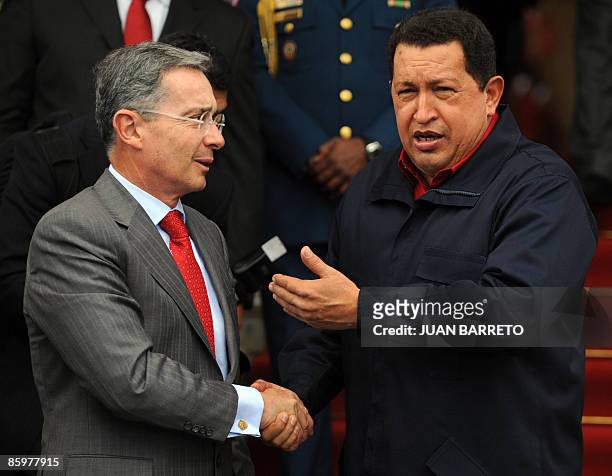 Venezuelan President Hugo Chavez greets his Colombian counterpart Alvaro Uribe upon arrival at the Miraflores presidential palace in Caracas on April...