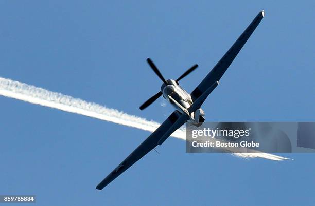 Mustang takes off from Plymouth Airport in Plymouth, MA as it intersects the contrail of a jet several miles above, after a three-day show at...