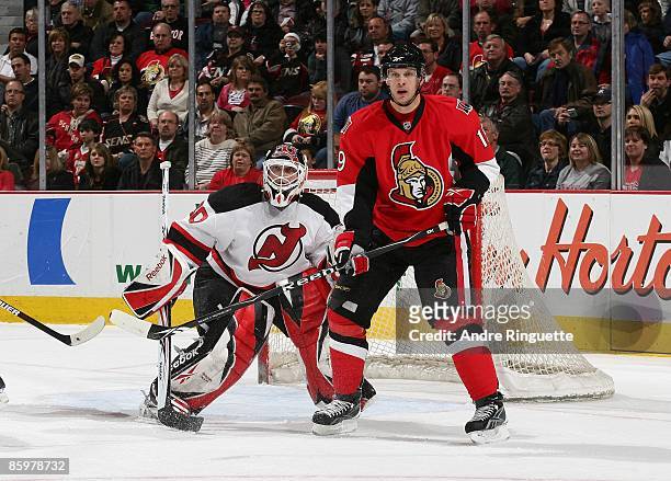 Jason Spezza of the Ottawa Senators skates against Martin Brodeur of the New Jersey Devils at Scotiabank Place on April 9, 2009 in Ottawa, Ontario,...
