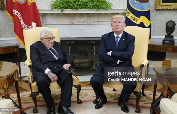 President Donald Trump meets with former US Secretary of State Henry Kissinger in the Oval Office of the White House on October 10, 2017 in...