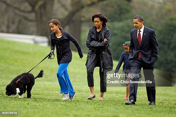 President Barack Obama , first lady Michelle Obama and their daughters, Sasha and Malia , introduce their new dog, a Portuguese water dog named Bo,...