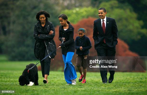 President Barack Obama , first lady Michelle and their daughters, Malia and Sasha introduce their new dog, a Portuguese water dog named Bo, to the...