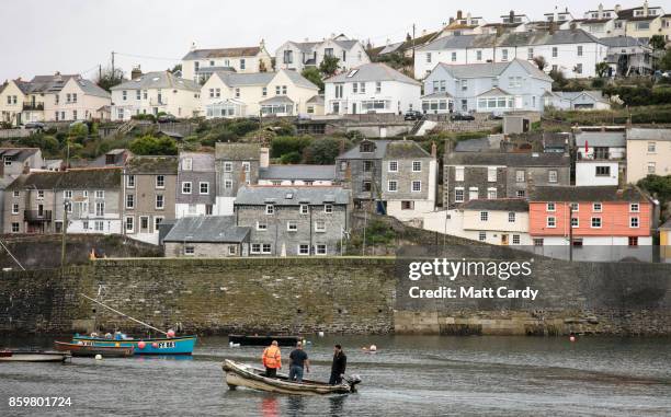 Fishermen enter the harbour in the village of Mevagissey which has submitted plans to limit the number of second homes on October 10, 2017 in...