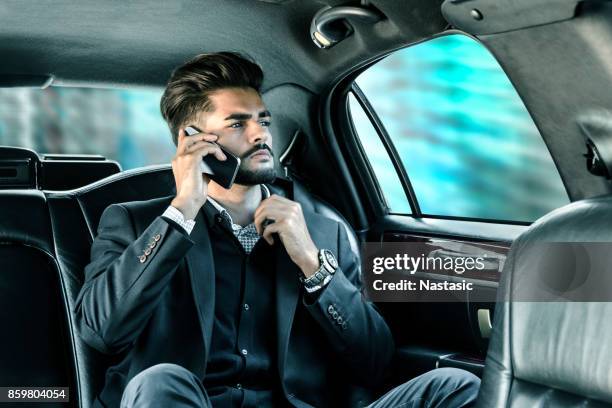 businessman talking on phone - limousine stock pictures, royalty-free photos & images