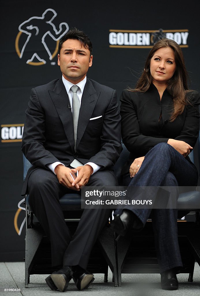 Oscar De La Hoya and his wife Millie Corretjer listen to Los Angeles