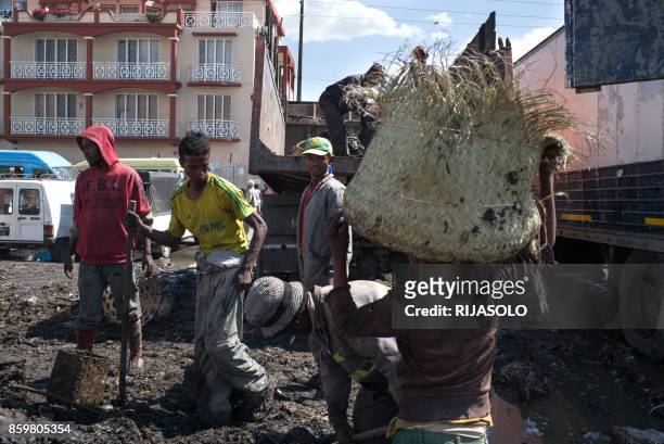 People clear garbage during the clean-up of the market of Anosibe in the Anosibe district, one of the most unsalubrious districts of Antananarivo on...