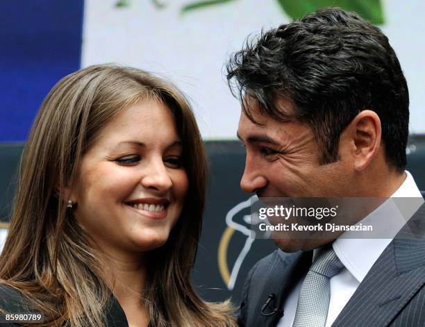 Boxer Oscar De La Hoya and his wife Millie Corretjer smile after he announced his retirement from boxing on April 14, 2009 in Los Angeles, California.