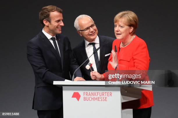 German Chancellor Angela Merkel is joined on stage by French President Emmanuel Macron and president of the German Publishers and Booksellers...