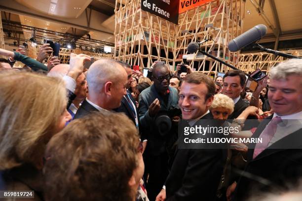 French President Emmanuel Macron visits the French pavilion after opening the Frankfurt Book Fair on October 10, 2017 in Frankfurt am Main, western...