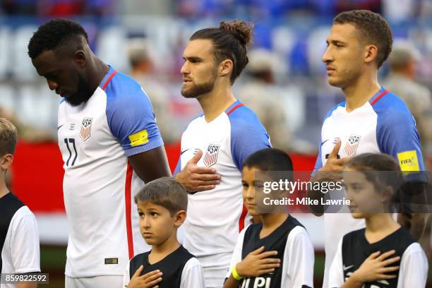 Jozy Altidore, Graham Zusi and Fabian Johnson of the United States look on during the national anthem before the game against Costa Rica during the...