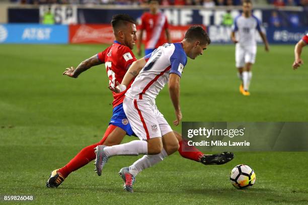 Christian Pulisic of the United States controls the ball against Francisco Calvo of Costa Rica during the FIFA 2018 World Cup Qualifier at Red Bull...