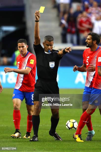 Referee John Pitti of Panama issues a yellow card against Costa Rica in the game against the United States during the FIFA 2018 World Cup Qualifier...