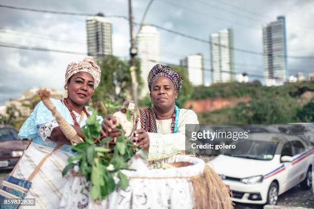 baiana and baiano in traditional costume doing religious ceremony in salvador - baiano stock pictures, royalty-free photos & images