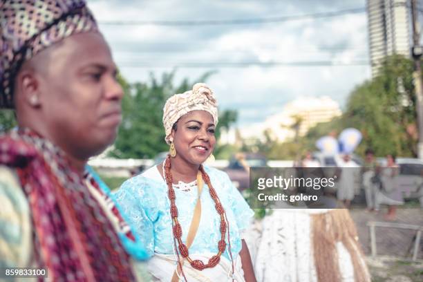 baiana and baiano in traditional costume doing religious ceremony in salvador - baiano stock pictures, royalty-free photos & images