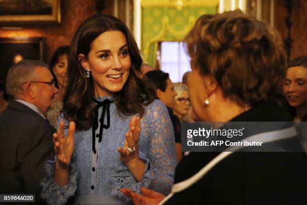 Britain's Catherine, Duchess of Cambridge attends a reception at Buckingham Palace to celebrate World Mental Health Day in central London on October...