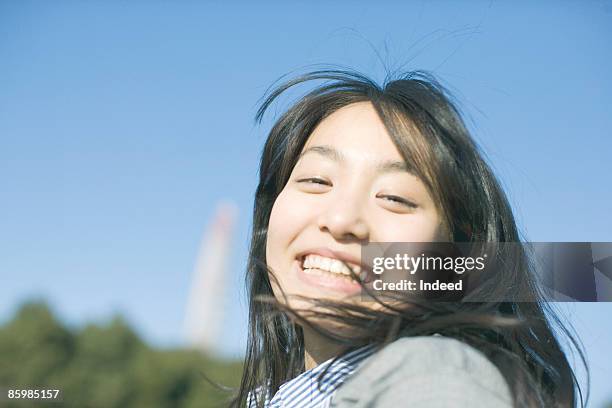 japanese woman smiling, portrait - tossing hair facing camera woman outdoors stock pictures, royalty-free photos & images