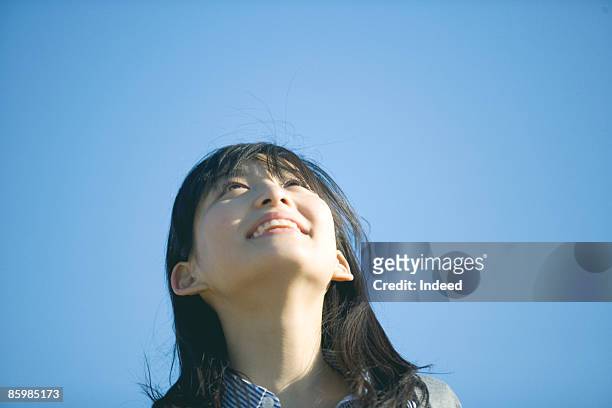 young woman looking at sky - japanese woman looking up stock pictures, royalty-free photos & images