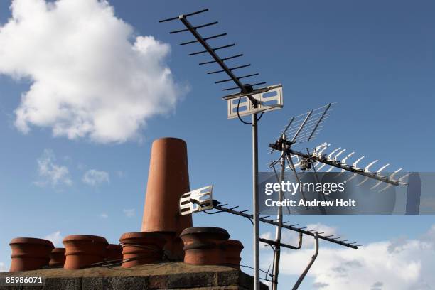 television aerials and chimney pots with blue sky - television aerial stock pictures, royalty-free photos & images