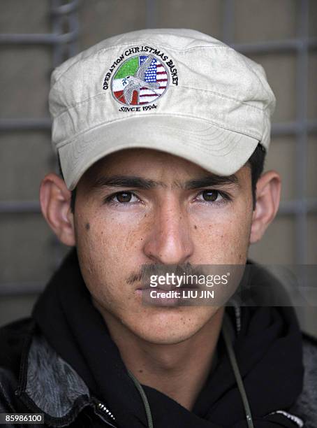 An Afghan worker waits for job distribution at ISAF's Camp Bostick in Naray, in Afghanistan's eastern Kunar province on April 15, 2009. United States...