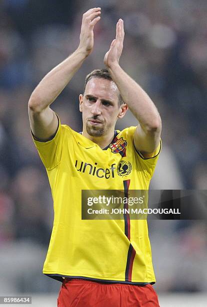 Bayern Munich's French midfielder Franck Ribery applauds supporters while wearing the FC Barcelona shirt of Barcelona's French defender Eric Abidal...
