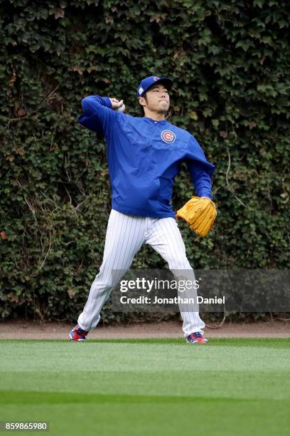 Koji Uehara of the Chicago Cubs warms up before game four of the National League Division Series against the Washington Nationals at Wrigley Field on...