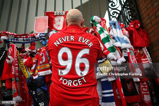 Liverpool fans pay their respects at the Hillsborough memorial at Anfield on April 15 Liverpool, England. Thousands of fans, friends and relatives...