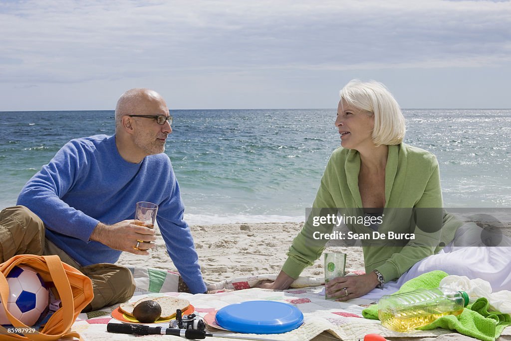Middle-aged couple relaxing on beach