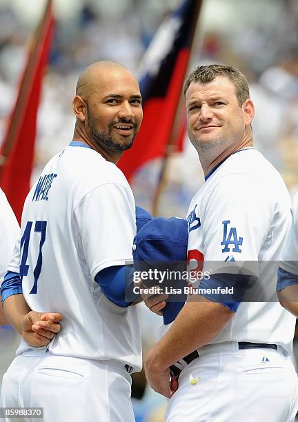 Cory Wade and Will Ohman of the Los Angeles Dodgers look on during ceremonies before the game against the San Francisco Giants on Opening Day at...