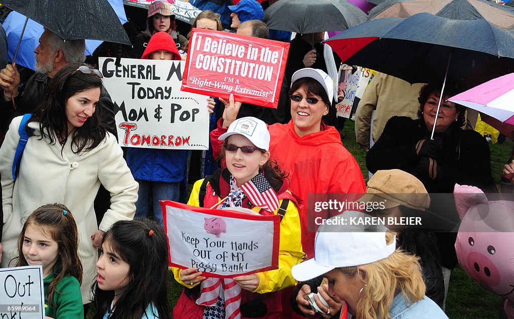 Protesters waves a signs during a "tea p