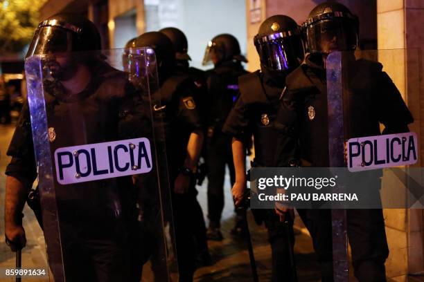 Spanish police patrol a street in Barcelona on October 10, 2017. Catalonia's leader Carles Puigdemont said he accepted the "mandate of the people"...